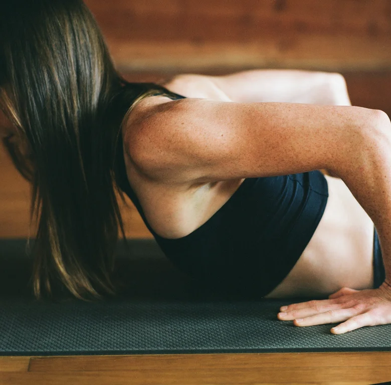 Student lifting into a backbend on a mat