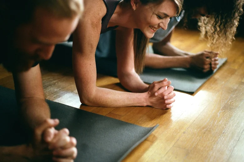 Students holding forearm plank side by side