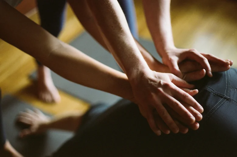 Close-up of a teacher's hands-on assist at the hips
