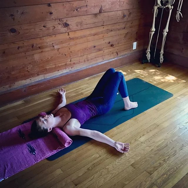 Savasana with a rolled blanket under the neck