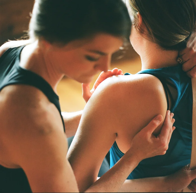 Teacher adjusting a student's shoulder