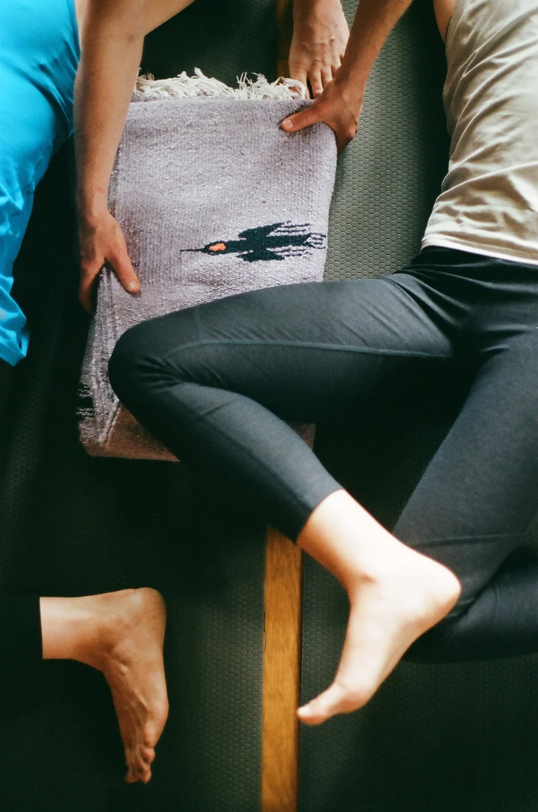 Student's legs supported on a blanket-covered bolster